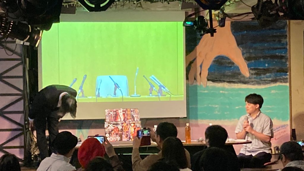 Yashiro Azuki entering the stage in a suit